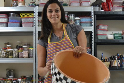 Ronit Strum in her studio, among shelves of glass and stone